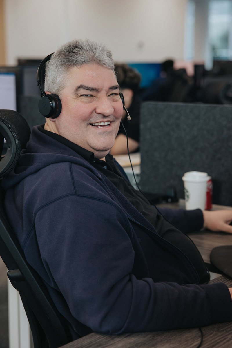 An employee sitting at their workstation