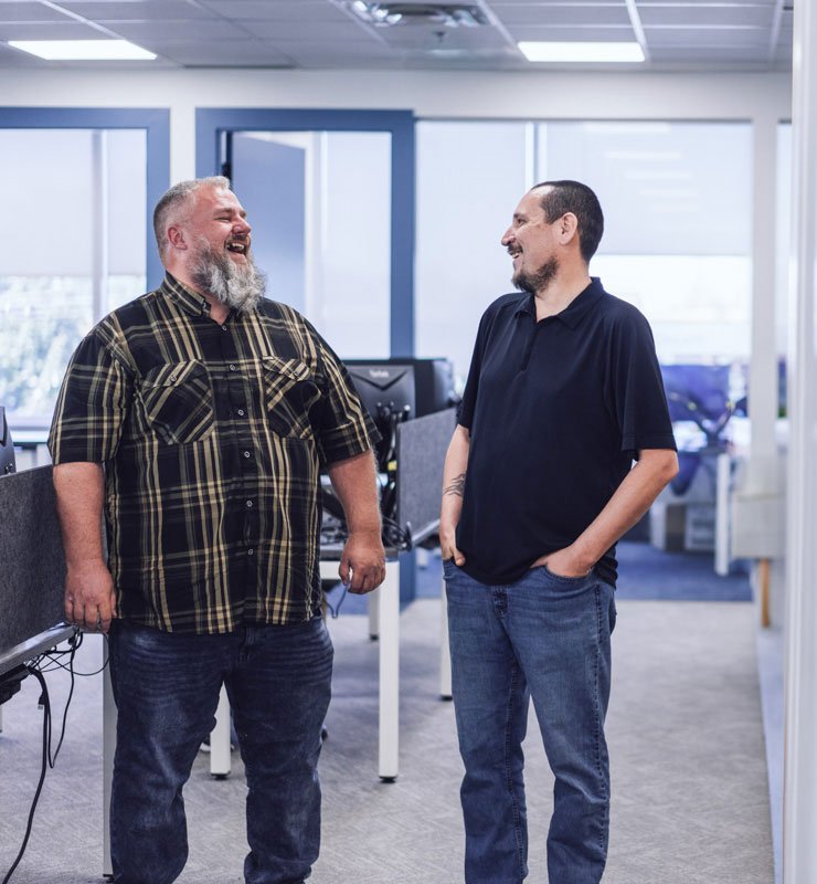 Two coworkers laughing in the office