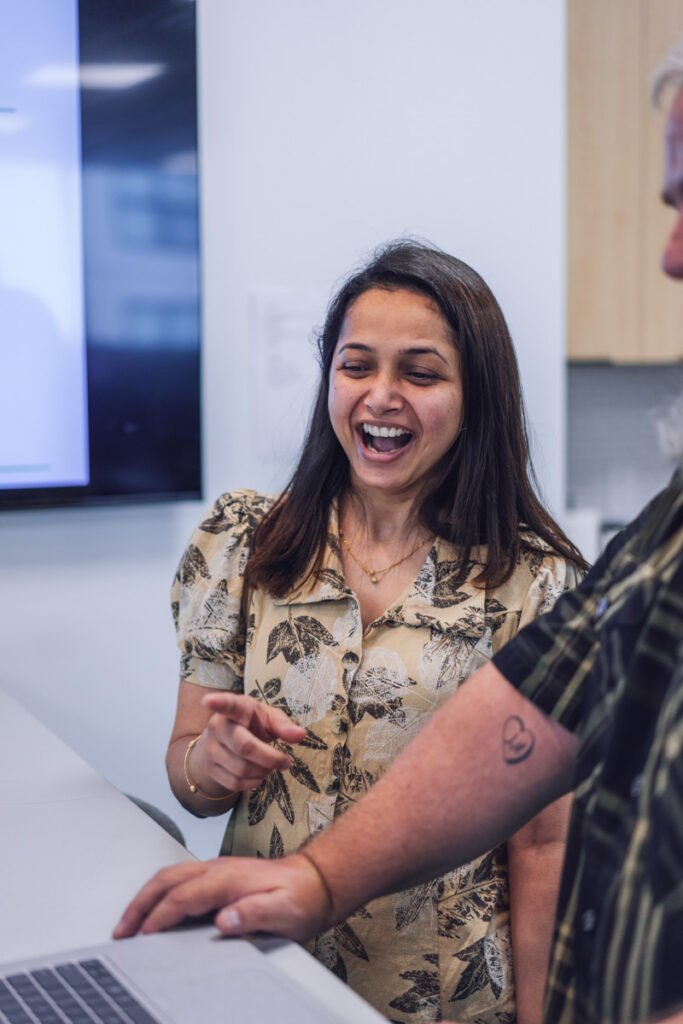 Two employees chatting and laughing