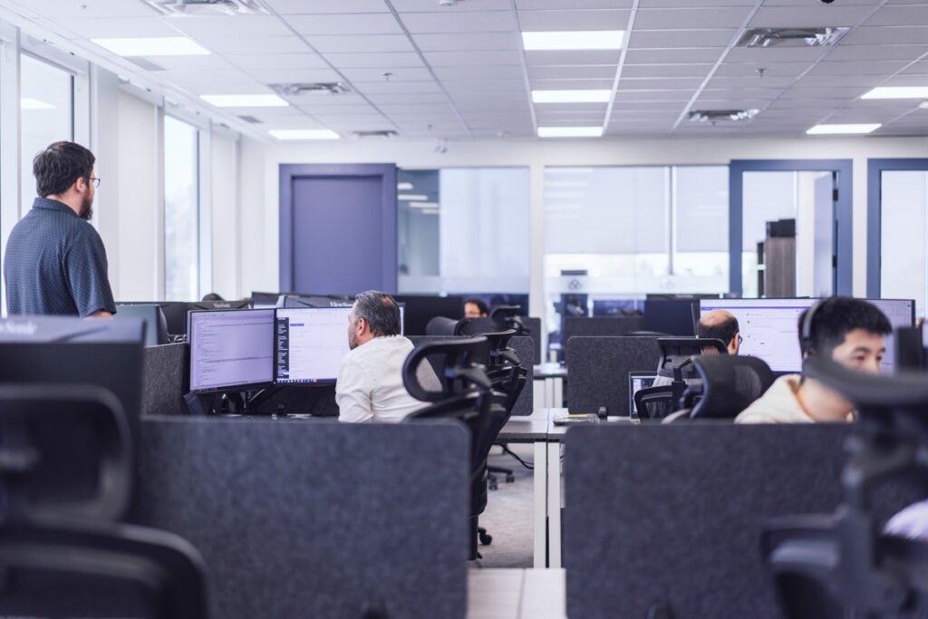 A group of coworkers sitting at their workstations