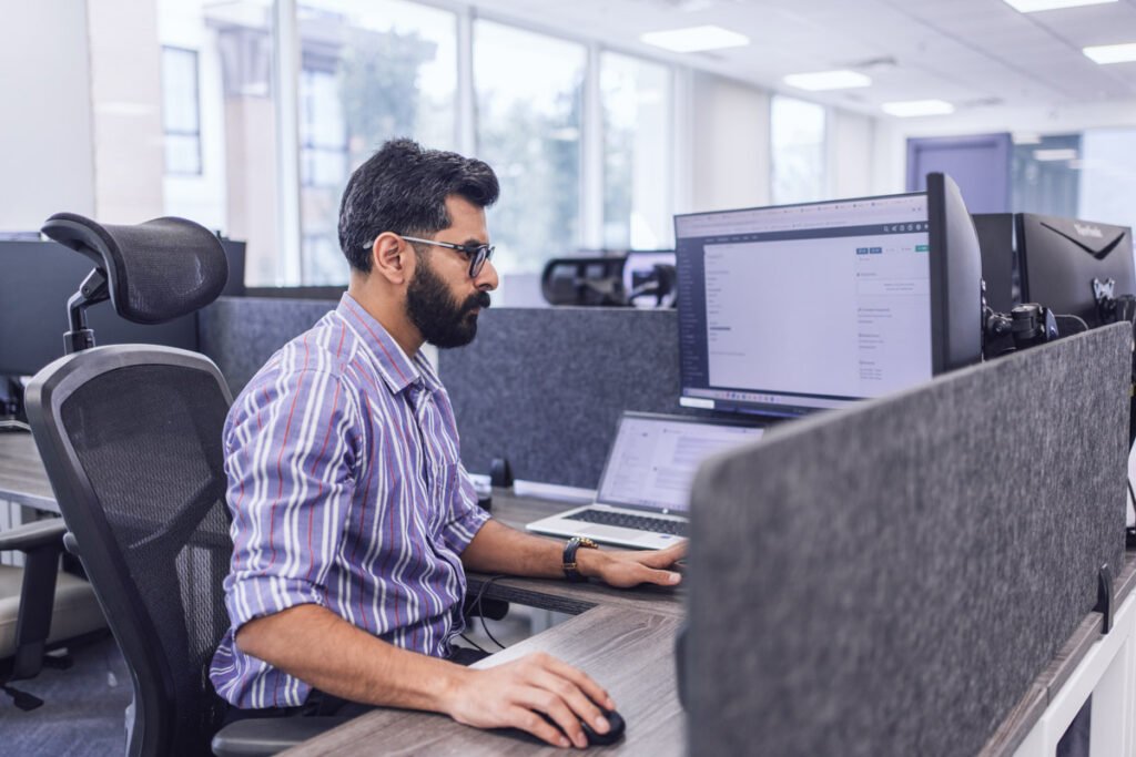 An employee sits at their workstation