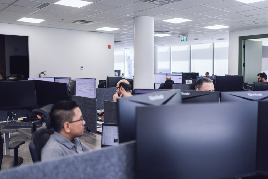 Employees sitting at their workstations in the office