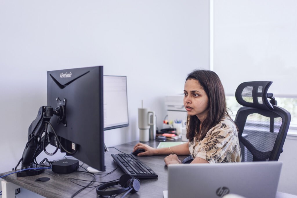 An employee sitting in their office working on their comuputer