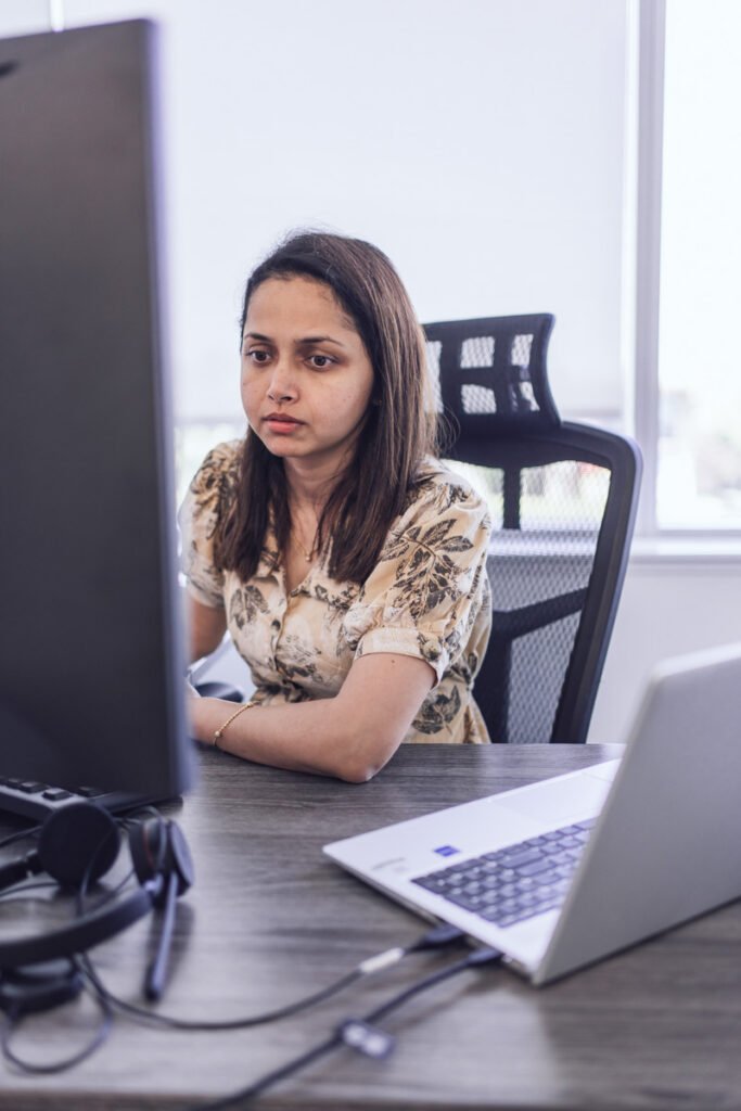 An employee sits at their desk working on their computer