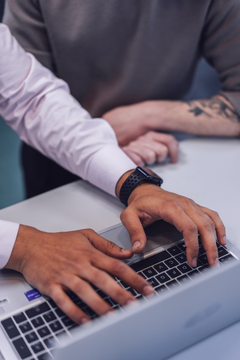 A person typing on their laptop