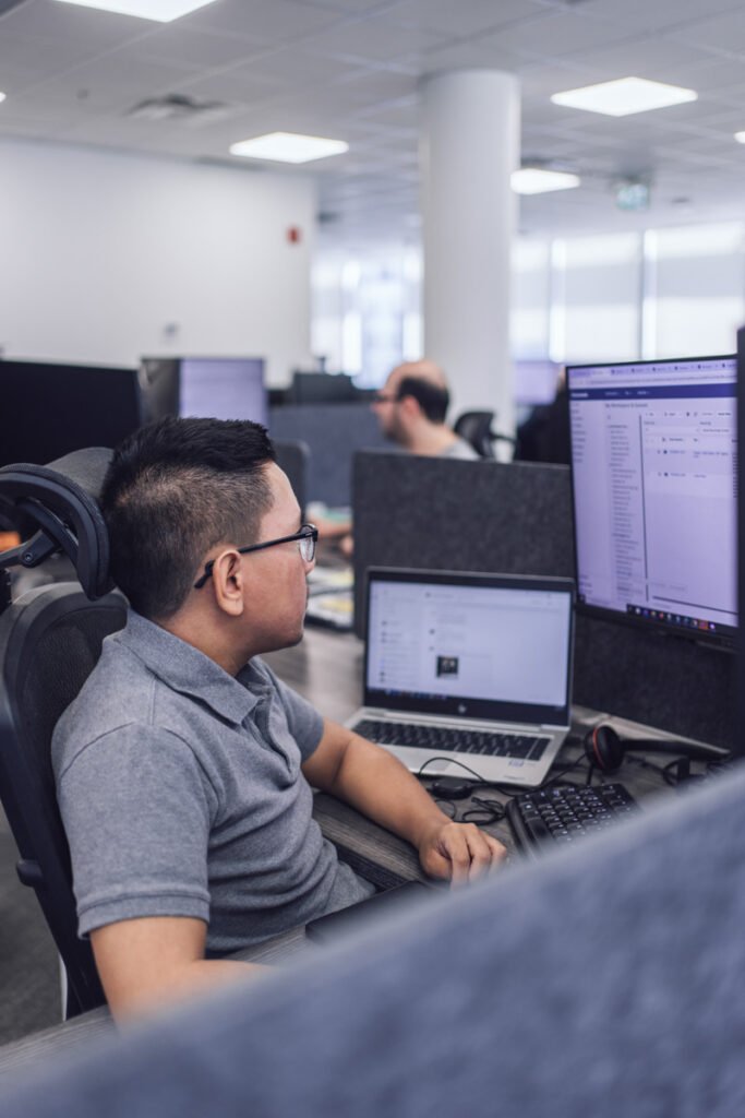 An employee sitting at their work station