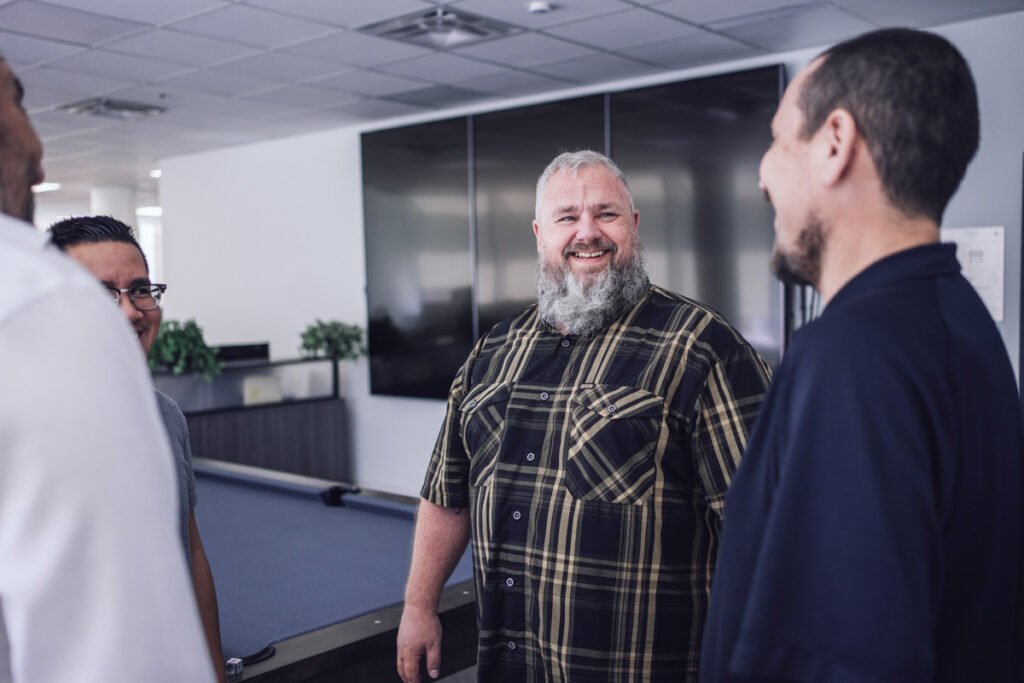 A group of coworkers talking in their office
